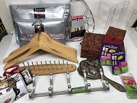 Full overview of lot showing hangers, lotion savers, Sole Mates shoe heel inserts, coat hooks, wood accessory rack, scarf hanger, earring holder, jewelry boxes, metal hand mirror, and Purse Innis packages.