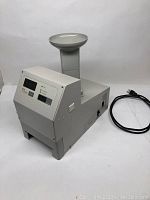 Front view of machine with tall chute and power cord adjacent