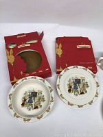 Two Bunnykins dishes (6.5" bowl and 6.5" plate) with red packaging boxes showing bunny graphics.