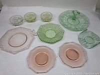 Full lot arranged: pink octagonal plate with handles, pink plates with chips, green textured octagonal plate, green curved dish, yellow scalloped bowls, large etched round dish with handle