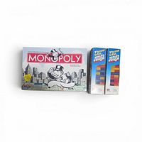 Monopoly box beside two Throw 'n Go Jenga boxes