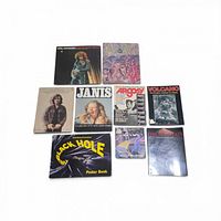 All nine items laid out – record and eight books