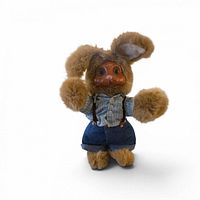Front view of Robert Raikos rabbit doll showing carved wooden face, plush body, clothing