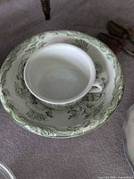 Basin and mug showing green floral transferware pattern