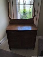 Front view of antique wash stand showing splashback and overall form