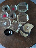 Assorted glass and ceramic ashtrays arranged on table