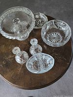 All crystal pieces on table: cake stand, serving bowl, shallow dish, oval dish, two candlesticks