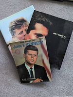 Front view of three JFK related books showing covers and titles