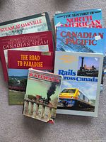 Stack of seven railroad-themed hardcover books