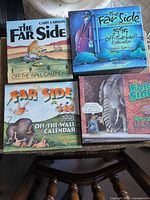 Front view of four Far Side calendars for years 1996-1999
