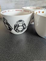 Wise Monkey cup exterior showing three monkey illustrations