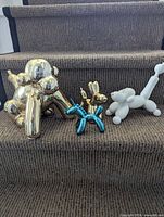 Group shot of all four balloon animal figurines on stairs