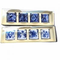 two boxed sets each containing four blue and white porcelain napkin rings