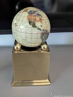 Front view of globe on brass plinth