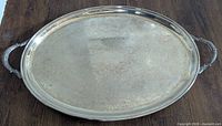 Top view showing oval engraved platter surface and handles