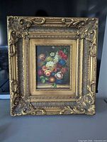 Full view of ornate gold frame and painting
