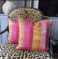 Pair of chevron striped cushions on leopard print chair
