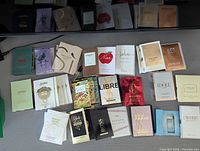 Full group shot of all 31 carded perfume samples spread on surface