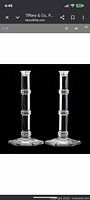 Front view of both crystal candlesticks showing full shape and pattern