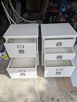 Both filing cabinets with drawers open showing interior and metal pulls