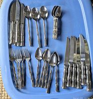 Entire assortment of bamboo-style cutlery arranged in tray