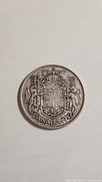Reverse view showing Royal Coat of Arms, denomination and date