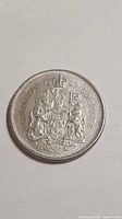 Reverse showing Canadian coat of arms and date