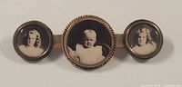 Front view showing three sepia portrait photos in round frames