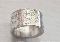 Close-up of ring showing engraved Tiffany Notes script and inner 925 stamp