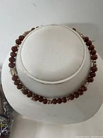necklace on display bust showing bead and charm arrangement