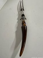 Full view of antique carving fork showing antler handle, guard, tines