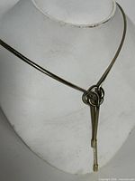 Full view of snake chain necklace on bust, showing knot slider and drop
