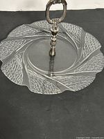Top view of round pressed crystal tray showing pattern and handle