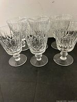 Six cut crystal wine glasses upright front view