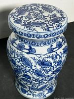 Angled view of blue and white ceramic garden stool with floral pattern