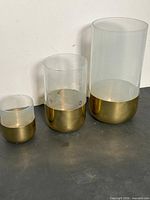 All three glass vessels front view showing size differences and gold-tone metal bands