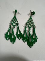 front view of green filigree chandelier earrings