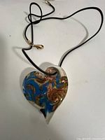 Front view of glass heart pendant on black cord
