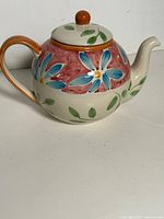left side view of floral ceramic teapot
