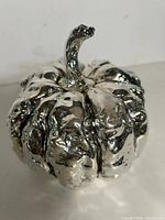front angled view of silver decorative pumpkin