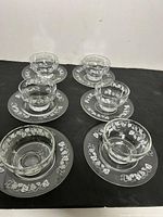 Six matching Dominion Glass Grapevine dessert bowls each on its saucer, full set visible
