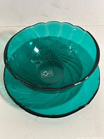 Bowl stacked on plate showing color and scalloped rims