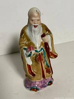 Front view of porcelain Shou Lao figurine showing colours, pose and condition