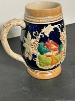 Full view of stein showing cottage scene and handle