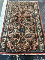 Full view of rug showing pattern, colors and fringe