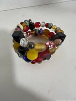 Side view of coiled bracelet showing variety of colourful beads