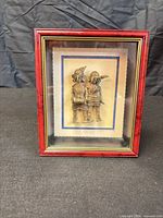 Front view showing framed Dhokra artwork