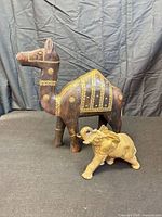 wooden camel and brass elephant together