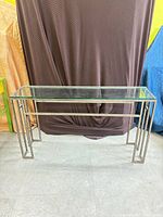 Front view of console table showing glass top and metal frame