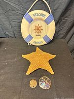 Life preserver plaque, starfish, two sand dollars overview